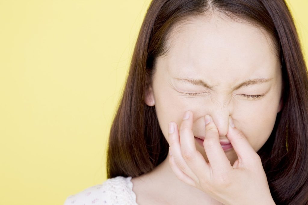 Irritated Woman due to foul smell